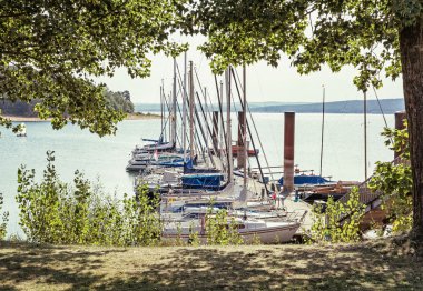 Sailboats at the pier in Brombachsee, Germany clipart