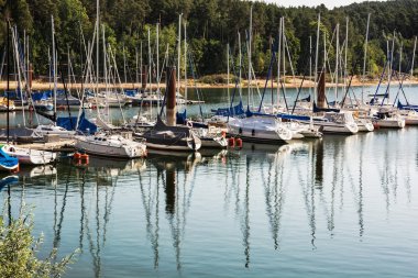 Sailboats at the pier in Brombachsee, Germany, summer vacation clipart