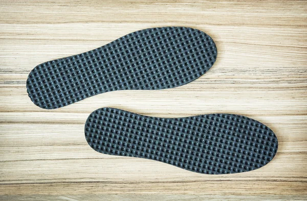 New shoe insoles on the wooden background — Stock Photo, Image