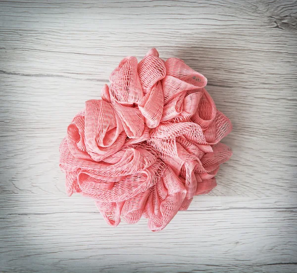 Roze washandje op de houten achtergrond — Stockfoto