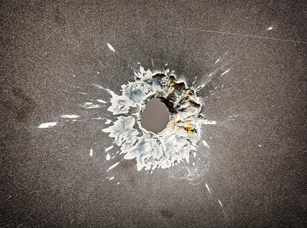 Bullet hole in the metal plate — Stock Photo, Image