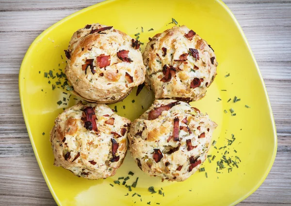 Delicious muffins stuffed with ham and cheese on the plate — Stock Photo, Image