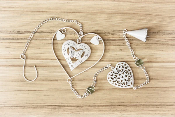 White hanging decoration with hearts on the wooden background — Stock Photo, Image