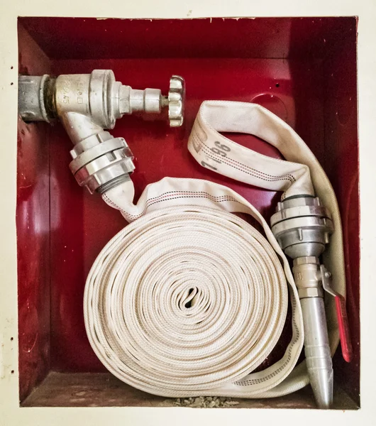 Fire cock with stacked hose, modern system — Stock Photo, Image