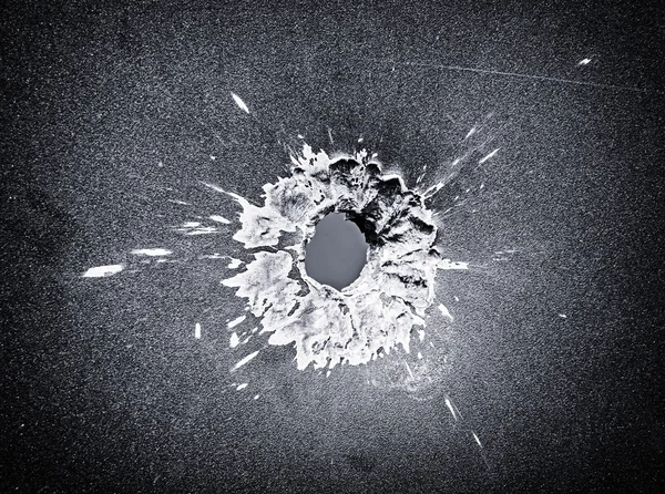 Bullet hole in the metal plate, black and white photo — Stock Photo, Image