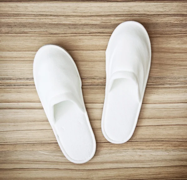 White slippers on the wooden texture, retro style — Stock Photo, Image