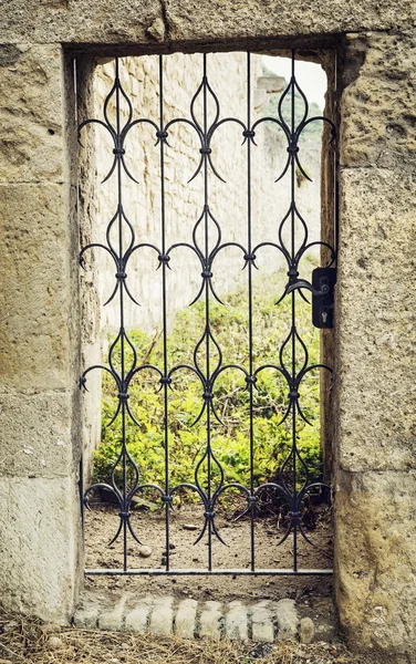Forged entrance gate in castle ruins — Stock Photo, Image