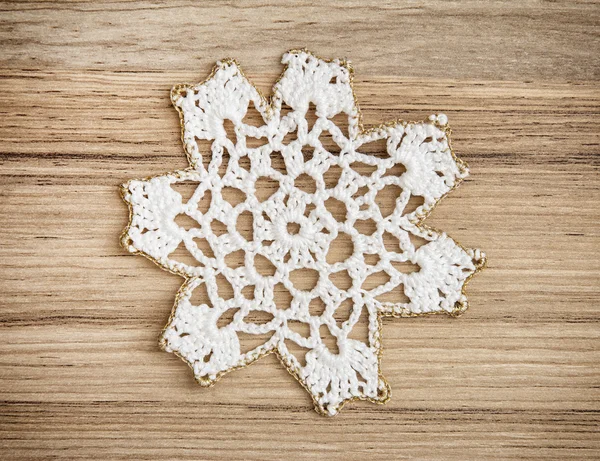 White crochet christmas decoration on the wooden background — Stock Photo, Image