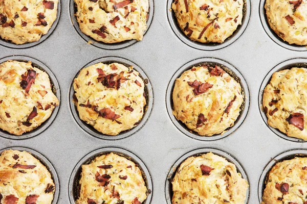 Delicious muffins stuffed with ham and cheese on the tray — Stock Photo, Image