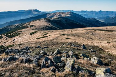 Tourists in Low Tatras mountains, Slovak republic. Hiking theme. Seasonal natural scene.