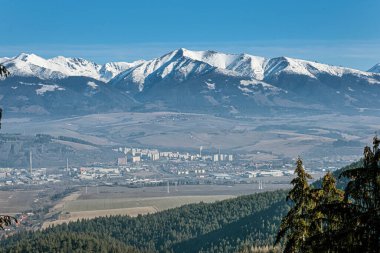 Western Tatras and Liptovsky Mikulas from Low Tatras, Slovak republic. Hiking theme. Seasonal natural scene. clipart