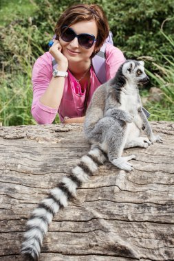 Ring-tailed lemur and young caucasian woman clipart