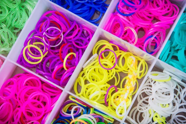 Caixa com muitas bandas de borracha coloridas para tear arco-íris — Fotografia de Stock