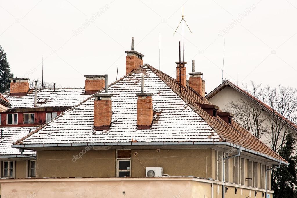 Red roofs of residential houses in winter