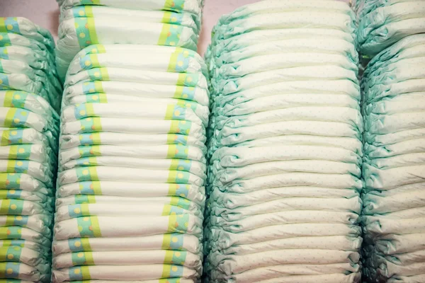 Children's diapers stacked in a many piles — Stock Photo, Image