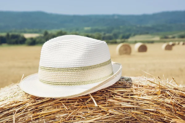 Frauenhut und gelber Heuhaufen — Stockfoto