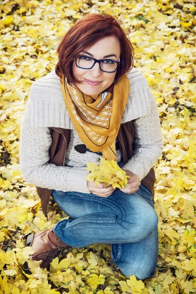 Giovane donna caucasica con foglie d'autunno gialle — Foto Stock