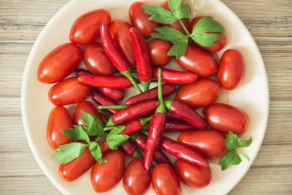 Chili peppers and cherry tomatoes — Stock Photo, Image