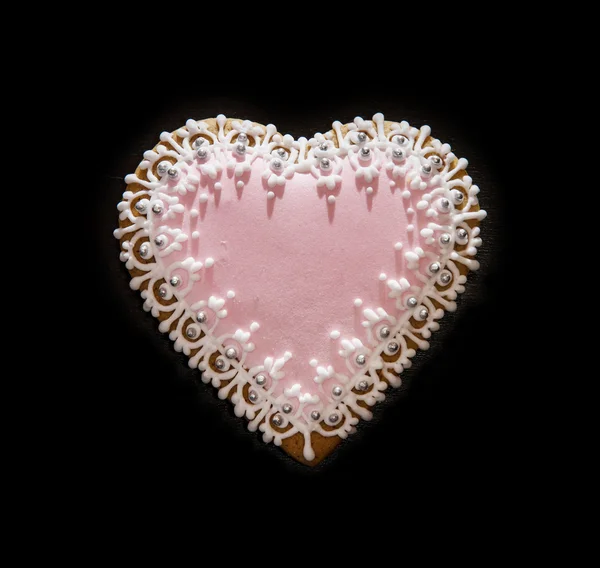 Gingerbread heart on the black background, symbol of lovers — Stock Photo, Image