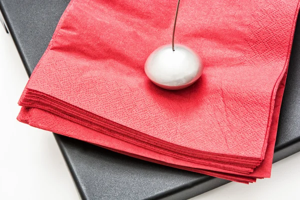 Napkin holder with paperweight and red napkins — Stock Photo, Image