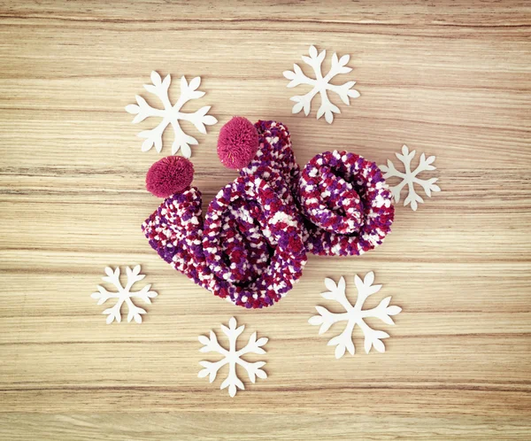 White snowflakes and knitted colorful socks, cool winter fashion — Stock Photo, Image