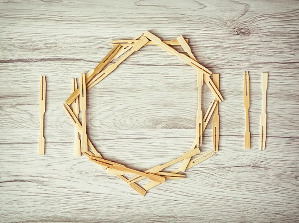 Cutlery with plate of toothpicks on the wooden background — Stock Photo, Image