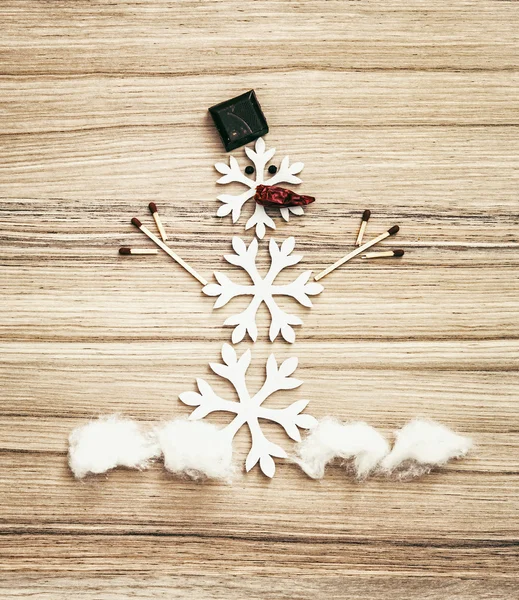 Beautiful snowman of snow flakes, matches, chocolate and chili p — Stock Photo, Image