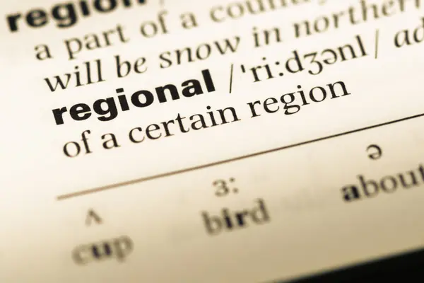 Close up of old English dictionary page with word regional — Stock Photo, Image