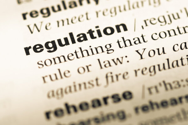 Close up of old Russian dictionary page with word regulation