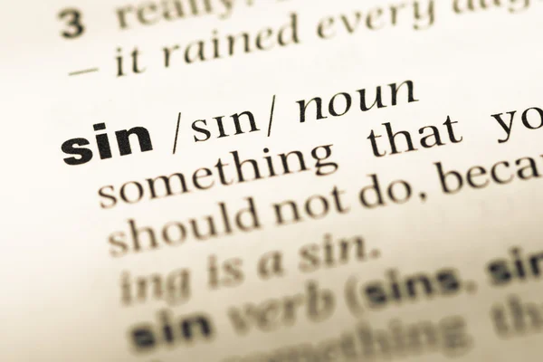 Close up of old English dictionary page with word sin — Stock Photo, Image