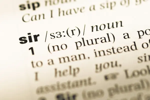 Close up of old English dictionary page with word sir — Stock Photo, Image