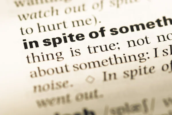 Close up of old English dictionary page with word in spite of — Stock Photo, Image