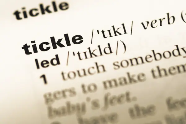 Close up of old English dictionary page with word tickle — Stock Photo, Image