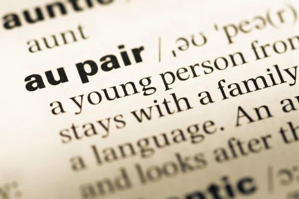 Close up of old English dictionary page with word au pair — Stock Photo, Image