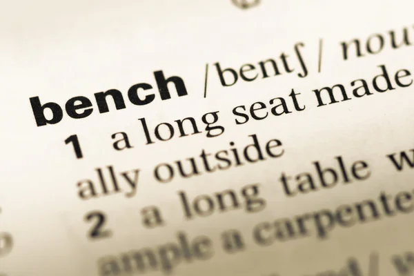 Close up of old English dictionary page with word bench — Stock Photo, Image