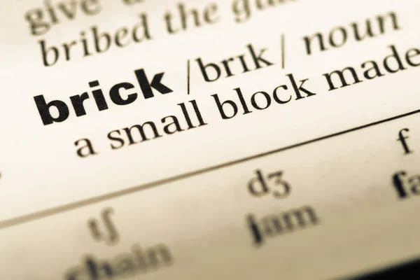Close up of old English dictionary page with word brick — Stock Photo, Image