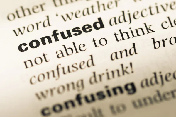 Close up of old English dictionary page with word confused — Stock Photo, Image