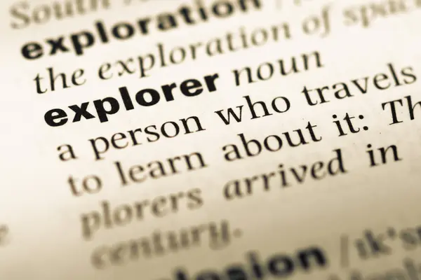 Close up of old English dictionary page with word explorer — Stock Photo, Image