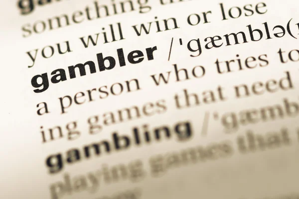 Close up of old English dictionary page with word gambler — Stock Photo, Image