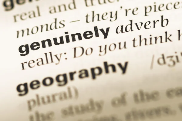 Close up of old English dictionary page with word genuinely — Stock Photo, Image