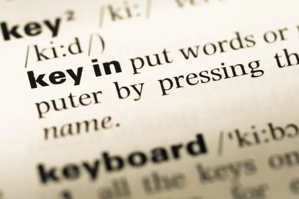 Close up of old English dictionary page with word key in — Stock Photo, Image