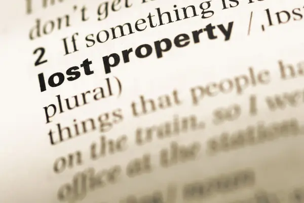 Close up of old English dictionary page with word lost property — Stock Photo, Image