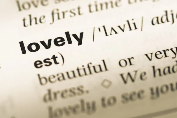 Close up of old English dictionary page with word lovely — Stock Photo, Image