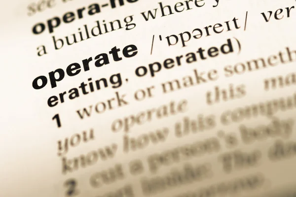 Close up of old English dictionary page with word operate — Stock Photo, Image