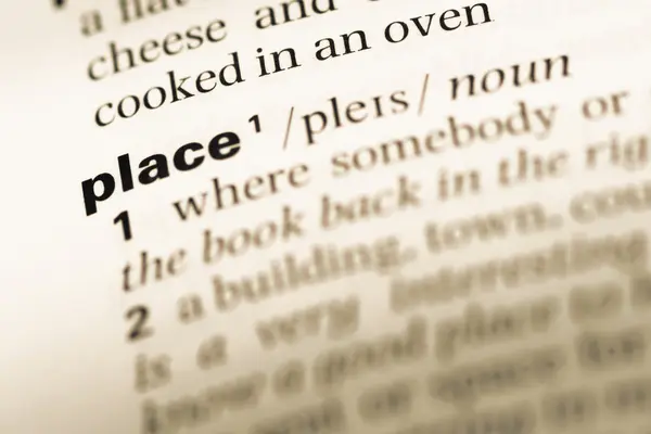 Close up of old English dictionary page with word place — Stock Photo, Image