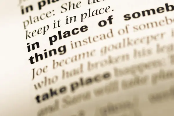 Close up of old English dictionary page with word in place of — Stock Photo, Image