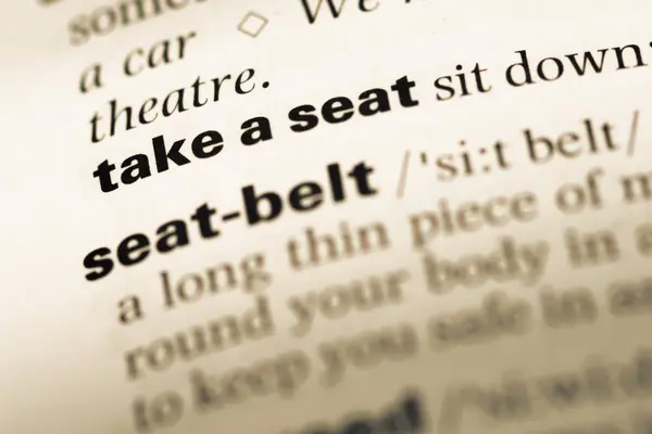 Close up of old English dictionary page with word take a seat — Stock Photo, Image