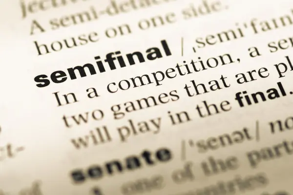 Close up of old English dictionary page with word semifinal — Stock Photo, Image