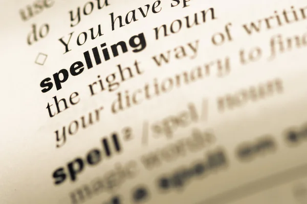 Close up of old English dictionary page with word spelling — Stock Photo, Image