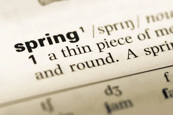 Close up of old English dictionary page with word spring — Stock Photo, Image